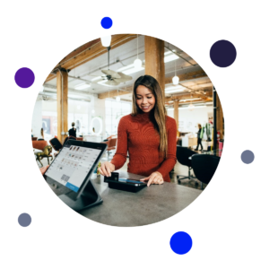 A woman paying for something at a till