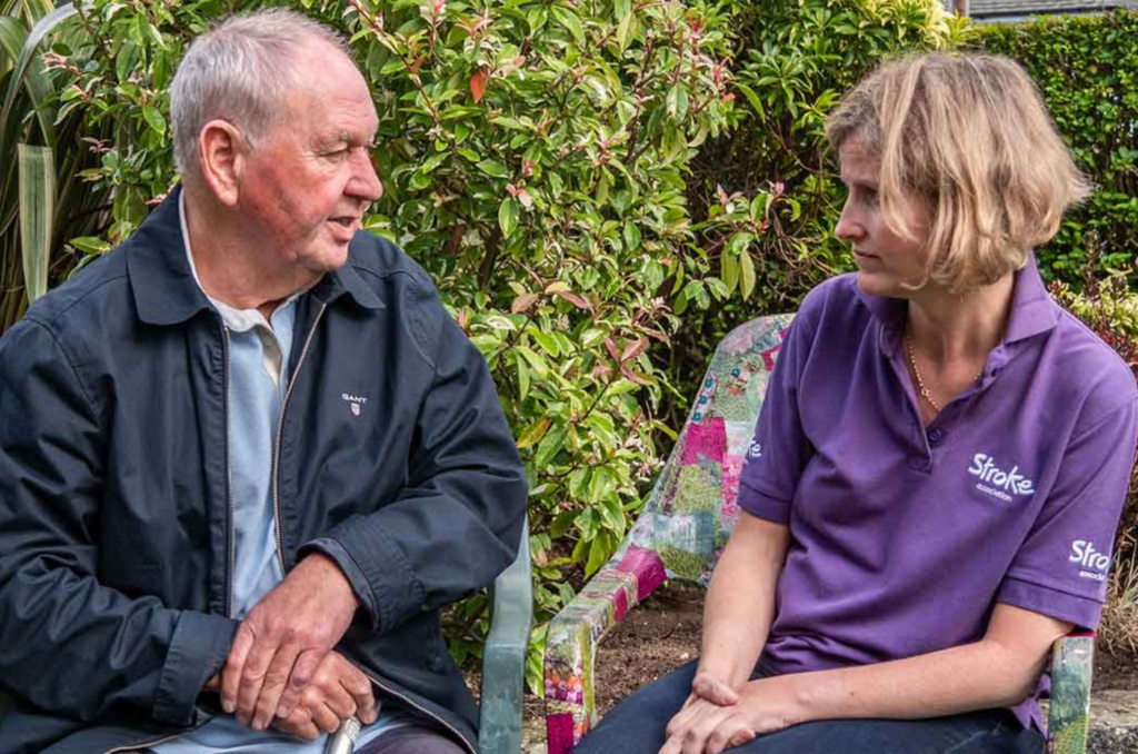 A Stroke Association volunteer sat with a stroke survivor